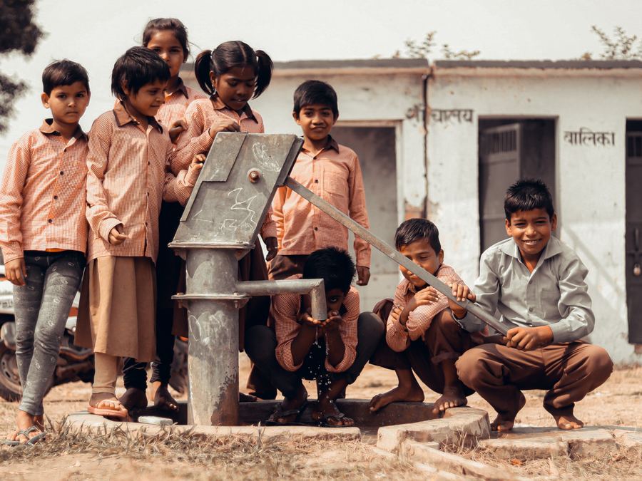 Children at a rural hand water pump
